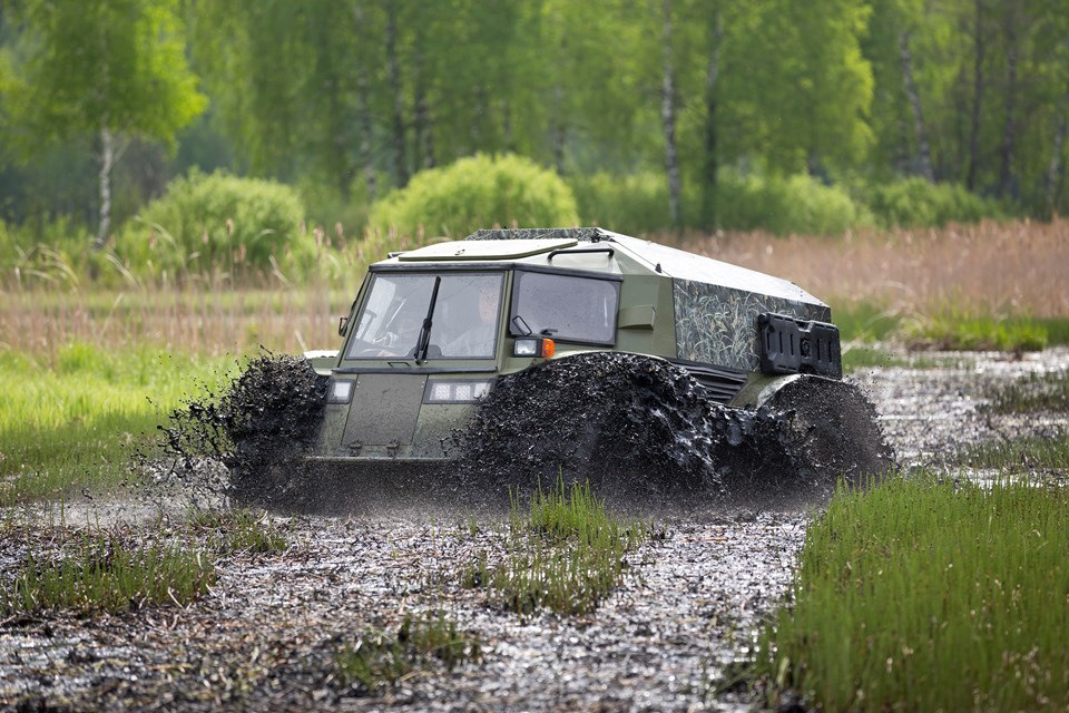 another sherp is driving while quarter submerged into mud on what looks like a flooded water meadow