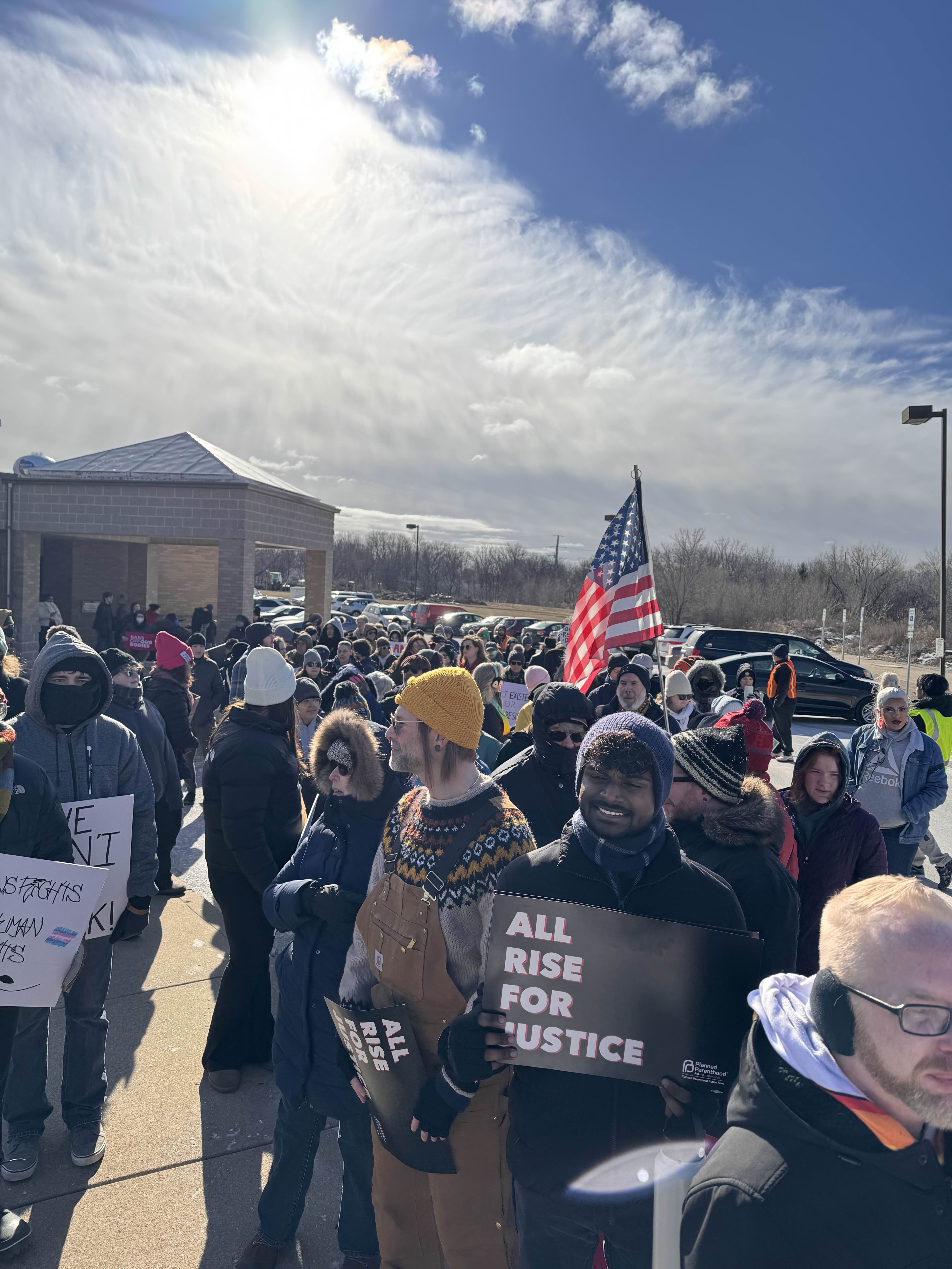 Large crowd gathered at Peoria Public Library for the People's March. 